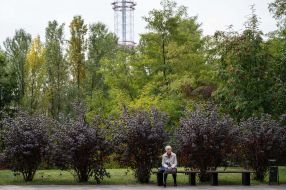 A woman is sitting on a bench