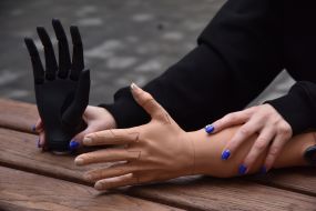 A woman presents hand prostheses