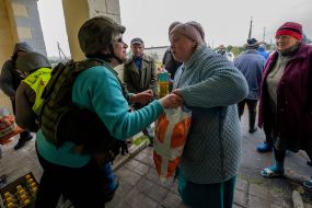 Volunteer distributes humanitarian aid to local residents