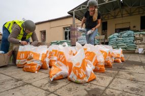 Volunteers sort humanitarian aid before distribution to local residents