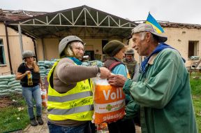 Volunteer distributes humanitarian aid to local residents