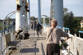 People walk along the surviving bridge in Izyum