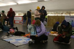 People are waiting for the air alarm at the subway station