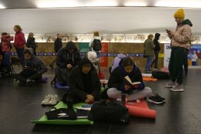 People are waiting for the air alarm at the subway station