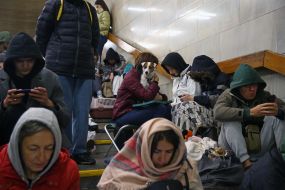 People are waiting for the air alarm at the subway station