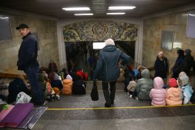 People are waiting for the air alarm at the subway station