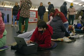 People are waiting for the air alarm at the subway station