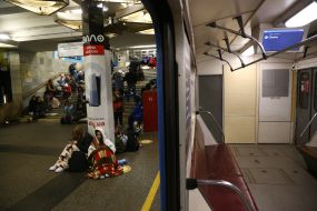 People are waiting for the air alarm at the subway station
