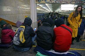 People are waiting for the air alarm at the subway station