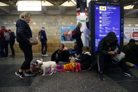 People are waiting for the air alarm at the subway station