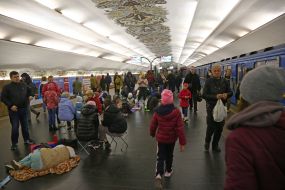 People are waiting for the air alarm at the subway station
