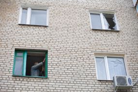 A local resident repairs windows in an apartment in Izyum