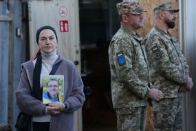 Woman holding a portrait of a deceased relative