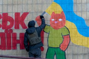 Kharkiv street art artists paint the wall of a house as part of the "Cultural Landing" event in the city of Kup'yansk
