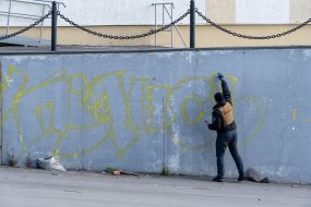 Kharkiv street art artists paint the wall of a house as part of the "Cultural Landing" event in the city of Kup'yansk
