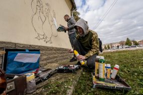 Kharkiv street art artists paint the wall of a house as part of the "Cultural Landing" event in Shevchenkove village