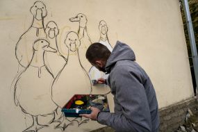 Kharkiv street art artist paints the wall of a house as part of the "Cultural Landing" event in Shevchenkove village