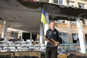 Ninth grader Mykyta near destroyed school in the village of Lyubimivka (Kherson region)