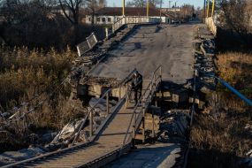 A man with a bicycle on the destroyed bridge in Vovchansk