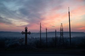 Cross and power lines near