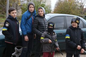 A boy with a toy weapon in de-occupied Kherson