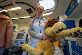 A neonatologist is holding a toy