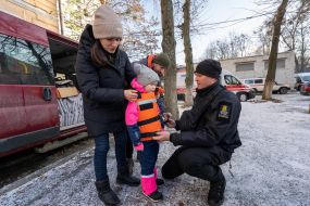 Volunteers demonstrate a children's body armor