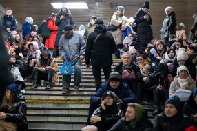 People are waiting for the air alarm at the subway station