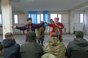 Artists perform in front of the military