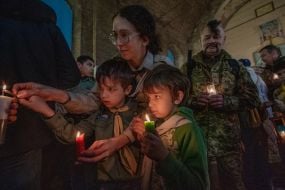Scouts light candles from the Bethlehem fire