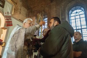 A member of the National Guard takes Holy Communion
