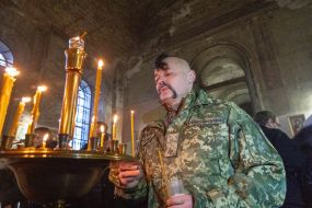 Serviceman of the Armed Forces of Ukraine puts candles