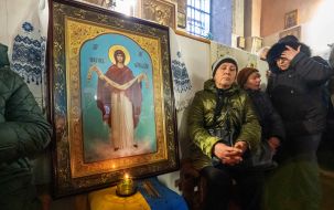 The believer sits near the icon