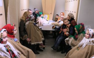 Participants of the festive procession in a shelter