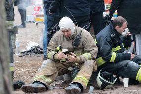 Lifeguard near a house destroyed by rocket fire