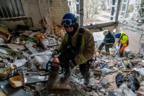 Rescuers are sorting through the debris in the destroyed apartment building