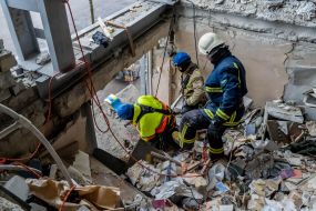 Rescuers are sorting through the debris in the destroyed apartment building