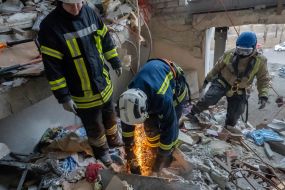Rescuers are sorting through the debris in the destroyed apartment building