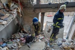 Rescuers are sorting through the debris in the destroyed apartment building