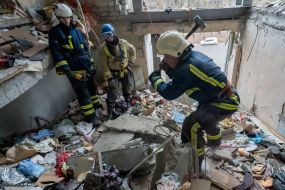 Rescuers are sorting through the debris in the destroyed apartment building