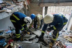 Rescuers are sorting through the debris in the destroyed apartment building