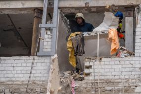 Rescuers are sorting through the debris in the destroyed apartment building