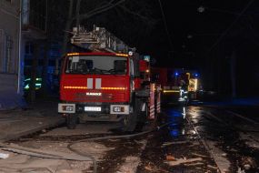 Fire engines near a residential building destroyed as a result of shelling