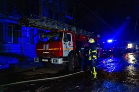 Fire engines near a residential building destroyed as a result of shelling