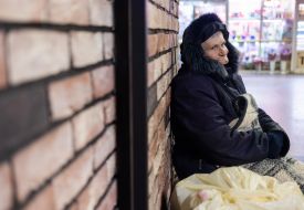 Homeless elderly woman in an underpass