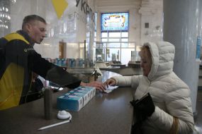 People exchange incandescent lamps for new energy-saving ones at the branch of Ukrposhta
