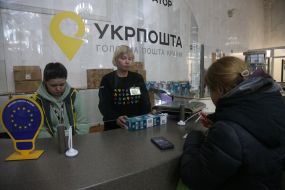 People exchange incandescent lamps for new energy-saving ones at the branch of Ukrposhta