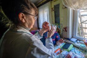 Family nurse Tetyana Bibik gives an injection to a patient