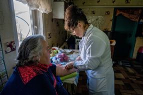 Family nurse Tetyana Bibik gives an injection to a patient