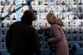 A woman near the Wall of Remembrance of those who died for Ukraine